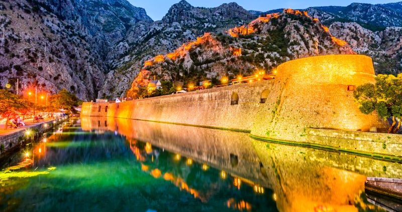 Bay of Kotor Montenegro. Venetian fortress of Kotor and Scurda river. Tower and wall mountain Lovcen at the background.