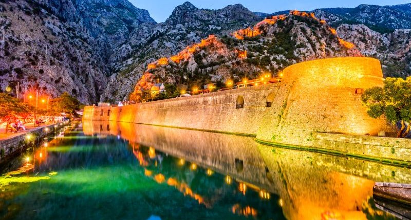 Bay of Kotor Montenegro. Venetian fortress of Kotor and Scurda river. Tower and wall mountain Lovcen at the background.