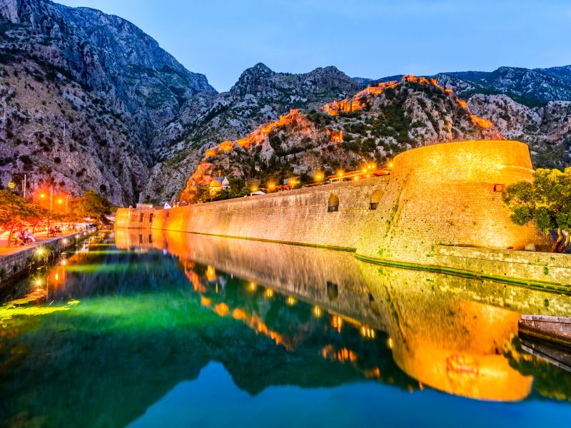 Bay of Kotor Montenegro. Venetian fortress of Kotor and Scurda river. Tower and wall mountain Lovcen at the background.