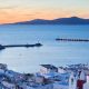 View of Mykonos town and Tinos island in the distance, Greece.