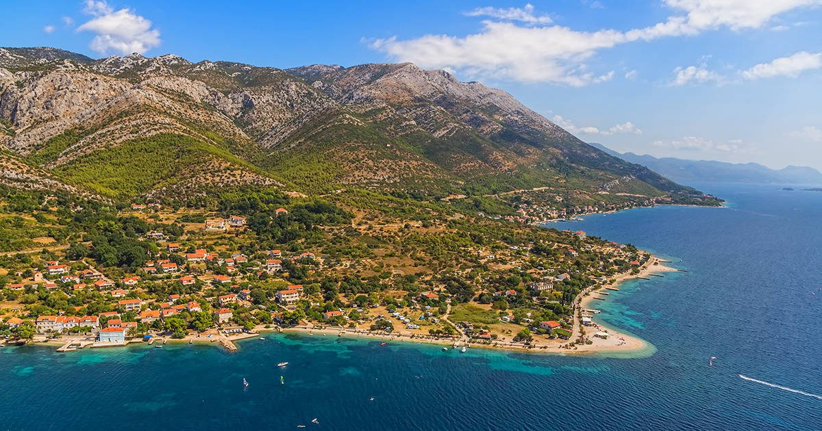 Helicopter aerial shoot of sandy beach Zrnovo near Orebic on Peljesac peninsula, Croatia. World known surfers destination